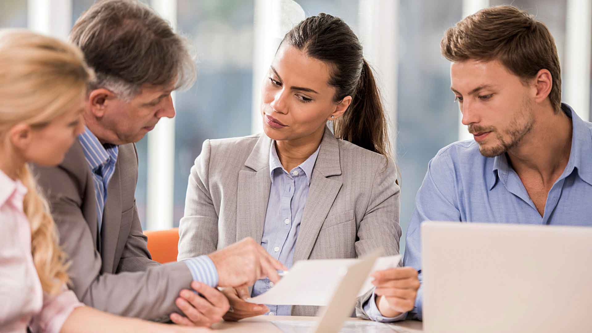 Marketing professionals in a strategy meeting discussing digital campaigns.